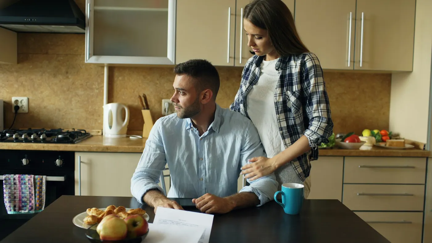 Homeowners reading over paperwork at their kitchen table